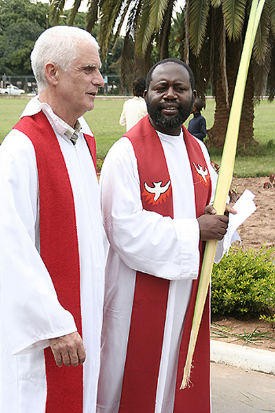 palm2 St. Ignatius priests Joe Kearney (l) and Fr Chilinda confer with each other