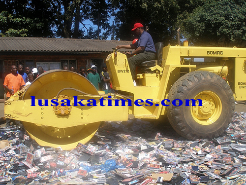 ronnie_shika1 Information minister Ronnie Shikapwasha destroying counterfeit goods on a bulldozer moration of the Intellectual Property Day in Lusaka