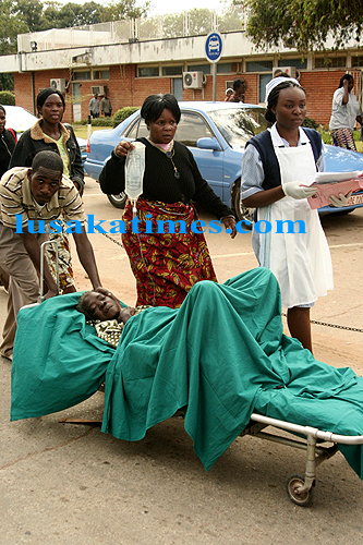 file:A student nurses helps a family transport a patient at the University Teaching Hospital because nurses are on strike