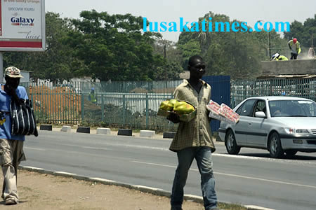 Street hawkers peddling their wares along the great east road at Mandhill Street hawkers peddling their wares along the great east road at Mandhill