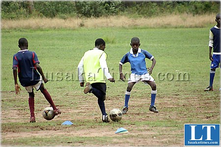 Yong boys playing social football at Lusaka club