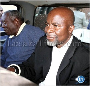Dr Katele Kalumba and Faustin Kabwe bundled in a police car after their sentencing to jail by a Lusaka magistrate Court