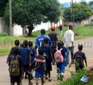 Some adults leading pupils going to school during the Mazabuka riots Some adults escorting pupils going to school