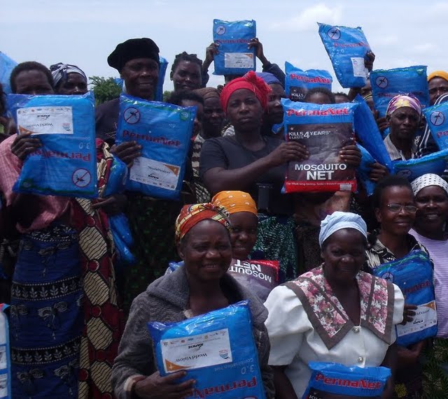 Women posing with their newly donated Mosquito nets