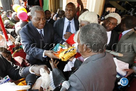 President Rupiah Banda hands over the instruments of power to President Michael Sata as Chief Justice Ernest Sakala looks on at the inauguration ceremony at the Supreme Court in Lusaka President Rupiah Banda hands over the instruments of power to President Michael Sata as Chief Justice Ernest Sakala looks on at the inauguration ceremony at the Supreme Court in Lusaka