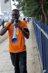 A soccer fan blows a vuvuzela along cairo road in Lusaka