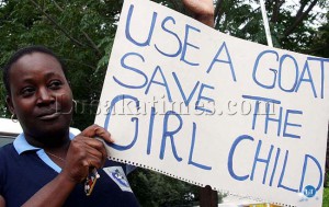 A woman hoists a message against defilement during the International Women's Day celebration in Lusaka A woman hoists a message against defilement during the International Women's Day celebration in Lusaka
