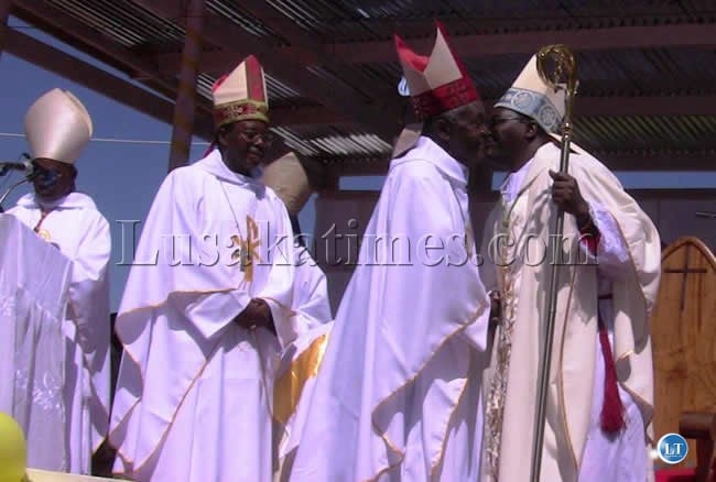 FILE:Archbishop Ignatius Chama (right) being congratulated by Emeritus Archbishop James Spaita after the ordination ceremony at Kasama’s St. Johns Cathedral this was attended by thousands of people from all walks of life.