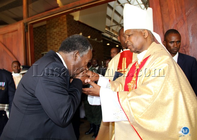 President Michael Sata kises the palms for Cardinal Merdado Mazombwe