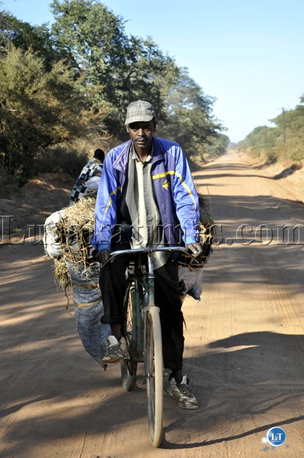 A man cycling bags of charcoal for sale from Chongwe rural to Chelstone in Lusaka