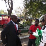 Legendary Soccer comentator Deniss Liwewe captured chatting with youths at the trade fair in Ndola.