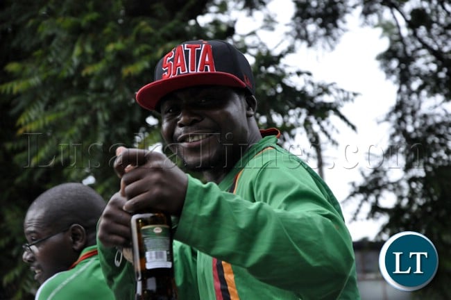 A soccer fan with a specially made Michale Sata cap in a high mood before the Zambia Bukina Faso game