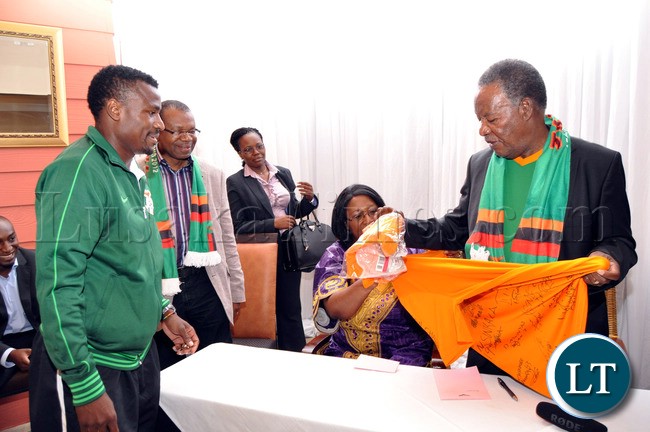 President Sata and First Lady Dr Christine Kaseba admires the Chipolopolo Jersey presented to them by National Team Captain Christopher Katongo