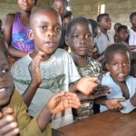 A bright future can be seen spilling out of these children's eyes as the clap in apriciation of the danation of books and desks fron the rotary club of Knwazi