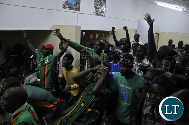 Soccer fans cheering the Chipolopolo team during the live broadcast of the match against Bukina Faso
