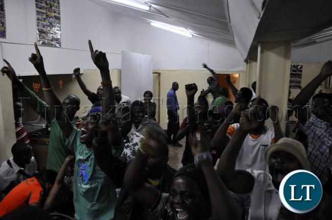 Soccer fans cheering the Chipolopolo team during the match against Bukina Faso.