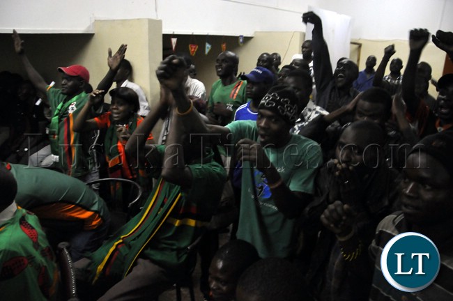 Soccer fans cheering the Chipolopolo team during the match against Bukina Faso