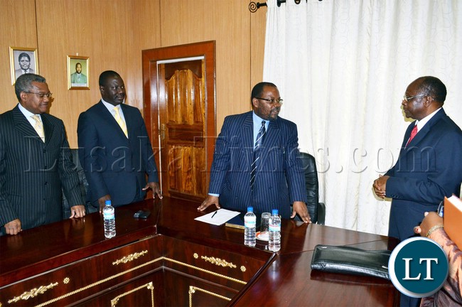 Transport, Works, Supply and Communications Permanent Secretary Muyenga Atanga (second from right) talks to Zambia Railways Board of Directors Chairperson Mark Chona (right) as Managing Director Professor Clive Chirwa (left) and Deputy Board of Directors Chairperson Professor Oliva Saasa look on