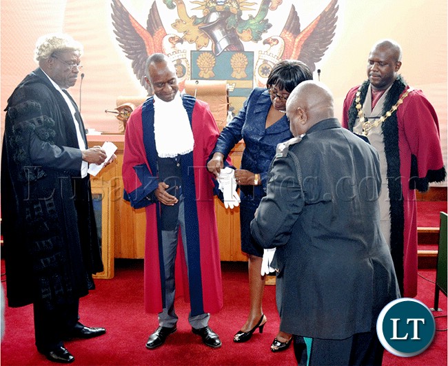 President Michael Sata's son Mulenga Sata putting on the Deputy mayor attire after he won the deputy mayoral election