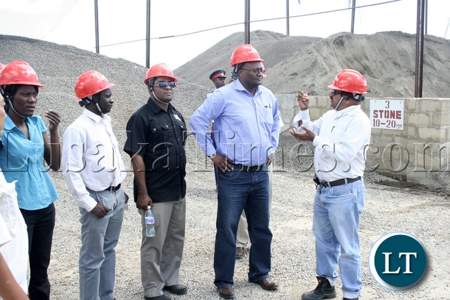 (Mongu-Kalabo Road) Rankin Resident Engineer Ramesh Suryawanshi speaking to Western Province Permanent Secretary Emmanuel Mwamba (c) and Mongu District Commissioner Maurice Litula during the inspection of AVIC bridge department at their comp site Mongu–Kalabo Road