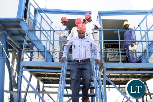 (Mongu-Kalabo Road) Western Province Permanent Secretary Emmanuel Mwamba coming out the stone mixing control room when he tour the AVIC bridge department at their comp site of Mongu–Kalabo Road