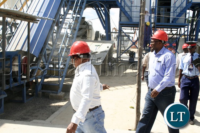 (Mongu-Kalabo Road) Western Province Permanent Secretary Emmanuel Mwamba being ushered the way at the stone mixing machine site when he tour the AVIC bridge department at their comp site of Mongu–Kalabo Road