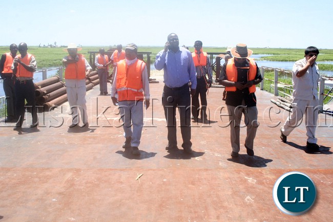 (Mongu-Kalabo Road) Western Province Permanent Secretary Emmanuel Mwamba third from (r) touring the temporal bridge which was put up by AVIC on the Zambezi River during the visits of the bridge on Mongu –Kalabo Road