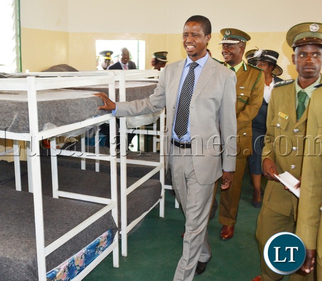 NICE beds…Home Affairs Minister Edgar Lungu flanked by Prison Service Commissioner Percy Chato (behind) inspect one of the dormitories for inmates at the newly commissioned Mwembeshi Maximum security prison in Mumbwa district