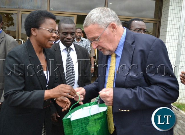Vice President Dr Guy Scott receives a gift from Oxfam Zambia Director Nellie Nyang'wa at the New Government Complex in Lusaka yesterday during the official opening of the Oxfam conference on Preparing Zambia to Create the Future