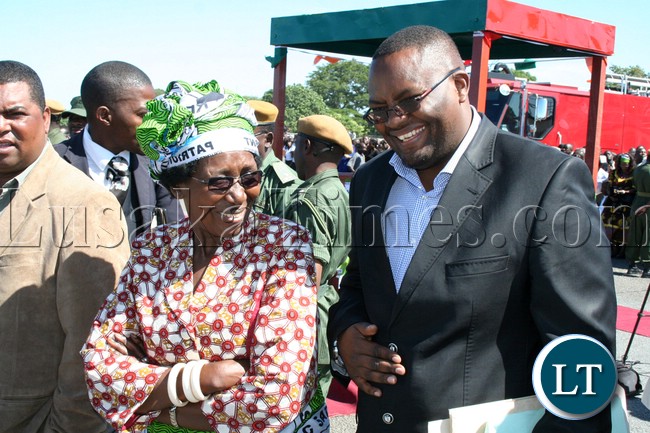 Minister of Gender and child Development Inonge Wina and Western Province Permanent Secretary Emmanuel Mwamba having the light moment shortly before President Michael Sata arrives at Mongu airport ahead of by-elections for Lukulu west
