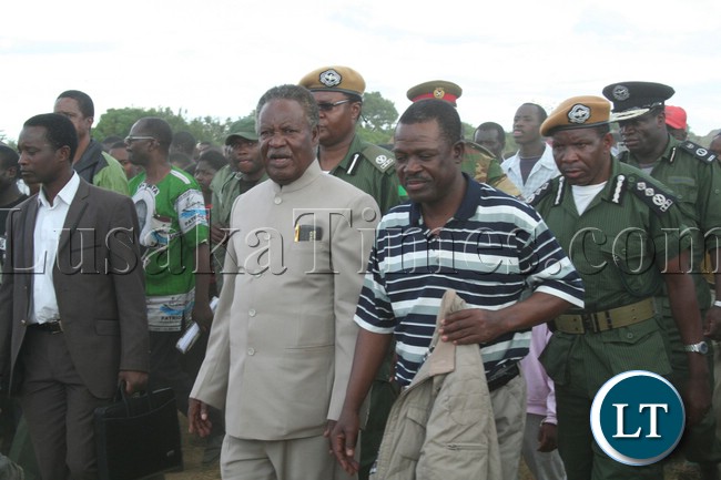 President Michael Sata walking to the rally arena upon arrival at meembe basic school grounds to drum up suport for the patriotic front candidate for the kapiri mposhi bye election Eddie Musonda , with his is (PF) general secretary Wynter Kabimba in lukanga swamps chipepo ward.