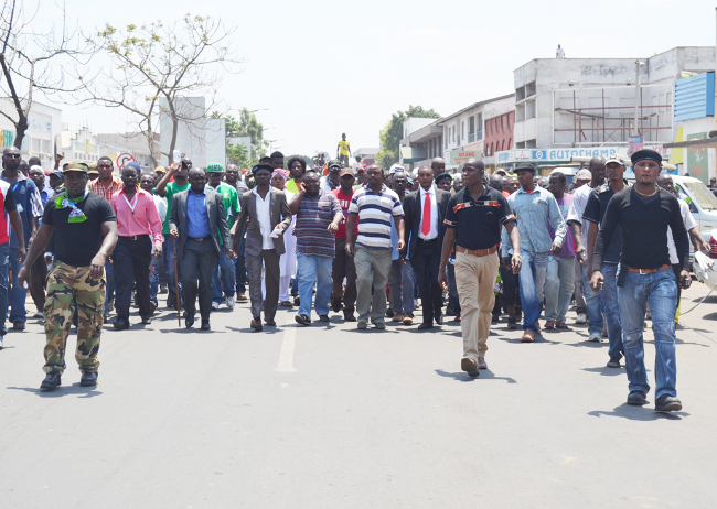 PATRIOTIC Front (PF) Lusaka Province youth chairperson Ackson Nkhoma (with black beret) and Lusaka District chairperson Robert Chikwelete (talking on the phone right) lead the ruling party’s cadres in demonstrating against their secretary-general Wynter Kabimba in Lusaka’s Freedomway