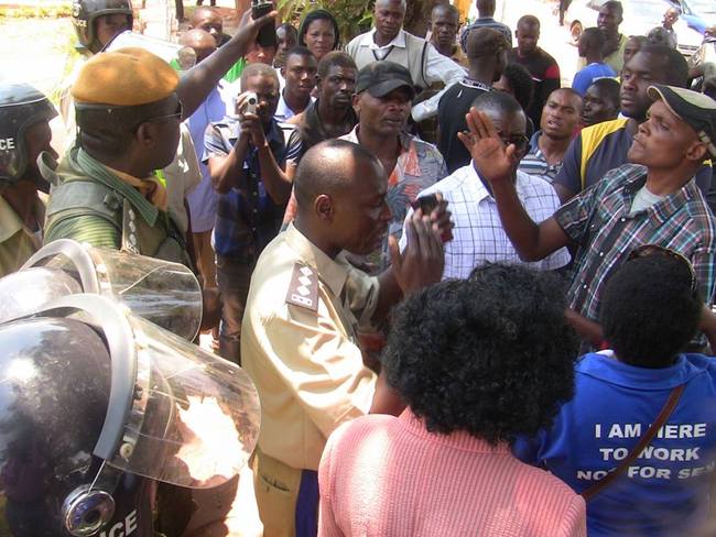 KASAMA Police officers persuading PF cadres to march off the Police station and not to disturb Hakainde Hichilema's movements. Picture coutesy ZANIS.
