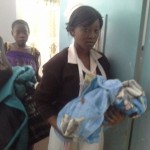 student Nurse at the labour ward helping new monther