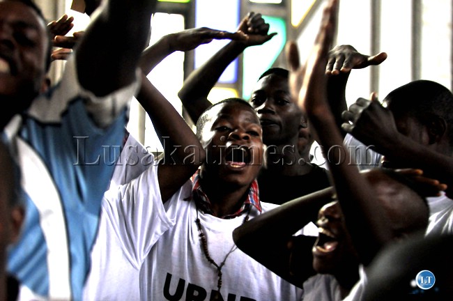 Youths from political parties chant slogans during the gathering to demand for the release of the draft Zambian constitution