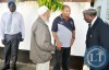 NATIONAL Sports Council of Zambia (NSCZ) chairperson Mwamba Kalenga (right), NSCZ board member Haroon Ghumra (third from right) and NSCZ acting general secretary Man Muchimba (right) consoling veteran soccer commentator and broadcaster Dennis Liwewe’s son Ponga at the funeral house in Lusaka