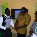 (Launch of the Office complex for ZNFU and E- Extension Service) Benson Mazyambe ZNFU IT Officer showing Agricultural minister Wylber Simusa on how to register the E-extension service whilst ZNFU president Dr. Evelyn Ngulelwa during the launch of E-extension service for the farmers