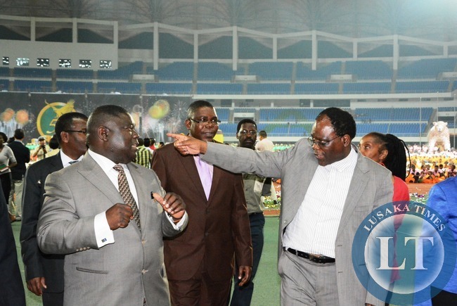Secretary to the cabinet Rawland Msiska chats with Communication Minister Yafya Mukanga who is flanked by Sports Deputy Minister Christopher Mulenga during the mass display of performance in preparation of Golden jubilee celebration