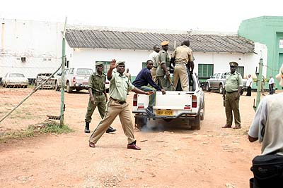 regina_in_van A prison guard blocking photographers from shooting pictures of Regina Chiluba at Chimbokaila