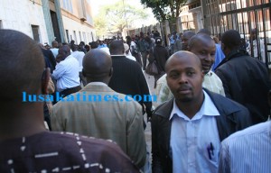 Scores of people waiting for their turn to apply for new passports