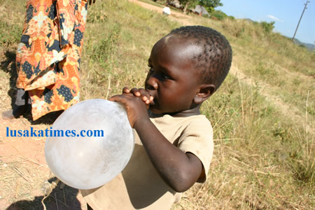 FILE: The other side of a condom. A 4 year old boy of Chienge District in Senior Chief Puta's area in Luapula Province playing with an inflated male condom