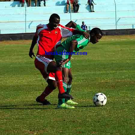 Green Buffaloes' Sebastian Mwansa shields the ball from Red Arrows' Joseph Zimba during the FAZ KCM premier division week 20 game played at Nkoloma stadium where Arrows won 3-0.