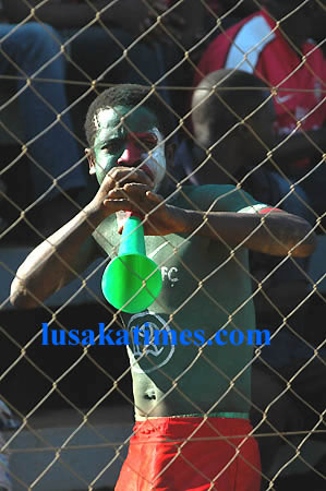 A Green Buffaloes supporter blowing a vuvuzela