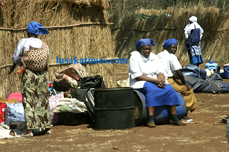 Some women from the Anglican church wait for transport after a blousing ceremony in Lusaka west.
