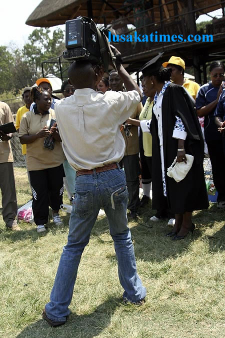 A cameraman in Lusaka struggling to shoot pictures of First Lady Thandiwe Banda in Lusaka