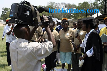 A cameraman in Lusaka struggling to shoot pictures of First Lady Thandiwe Banda in Lusaka