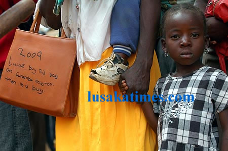 A woman carrying a souvenir and clenching her son's hand during the Kulamba traditional ceremony