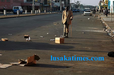 An old man walking along Freedom Way after vendors were removed from the street in Lusaka