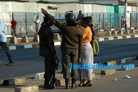 Police officers confront a street vendor during an operation to remove the hawkers from the street