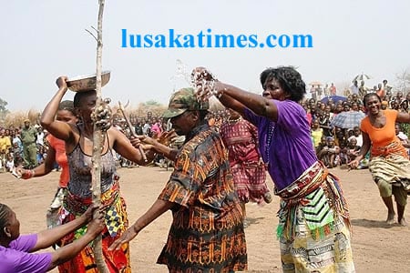Traditional counsins doing 'chimbuya' by spilling water on each other during the Malaila traditional ceremony in mabwe district
